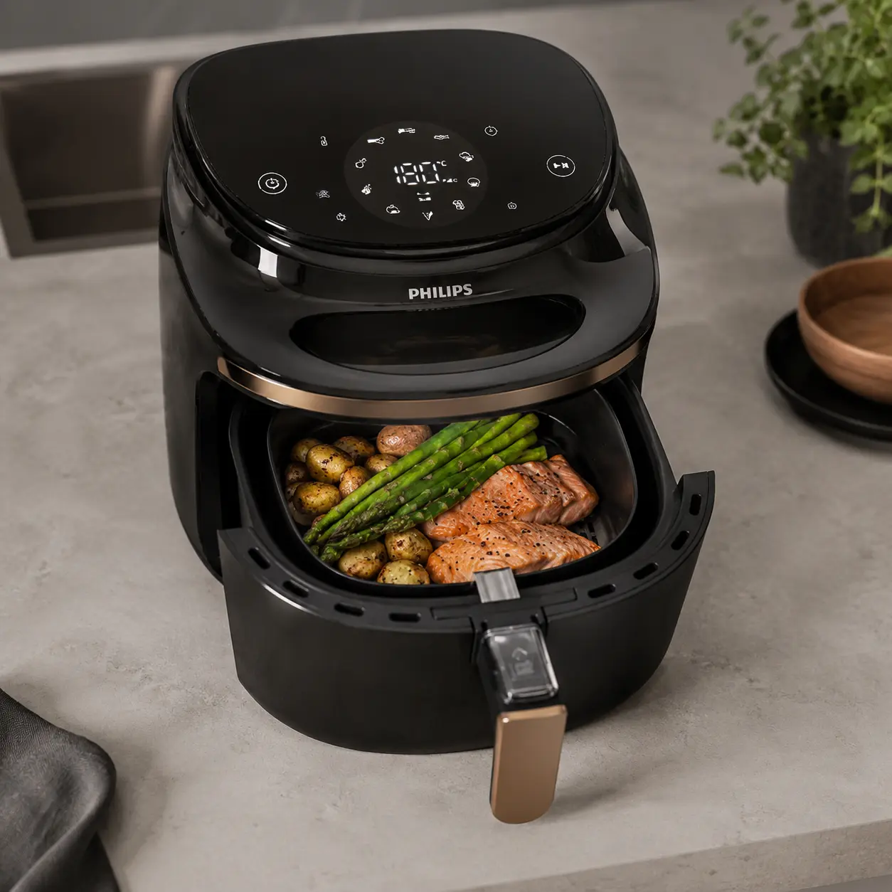 Freidora de aire Philips con tecnología RapidAir preparando alimentos dorados y crujientes